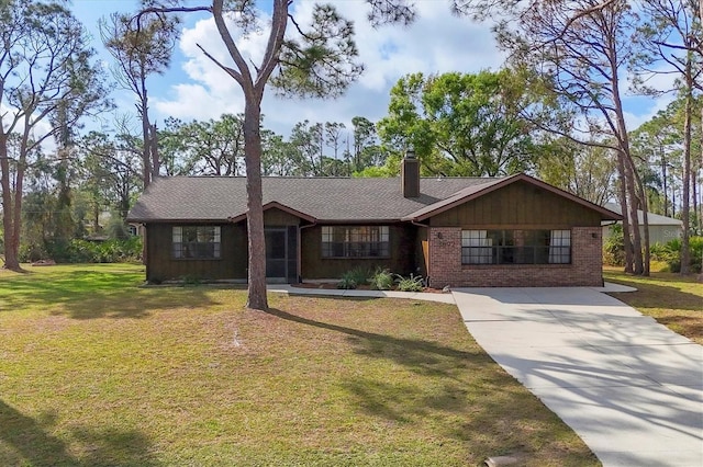 ranch-style house featuring driveway, a front lawn, a chimney, and brick siding