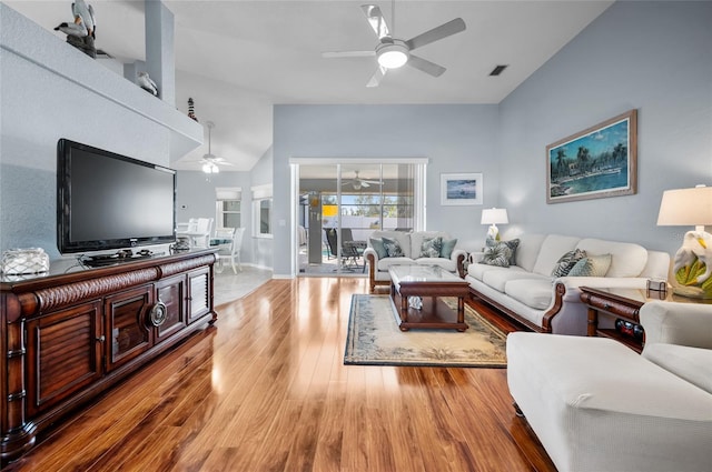 living room featuring high vaulted ceiling, ceiling fan, and light wood-type flooring