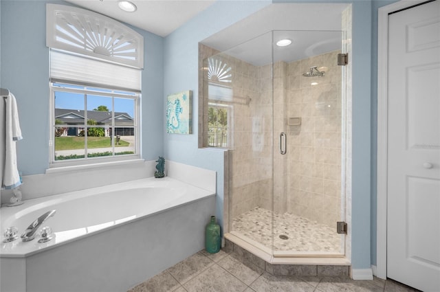 bathroom with separate shower and tub and tile patterned floors