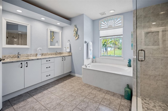 bathroom featuring vanity, tile patterned flooring, and separate shower and tub