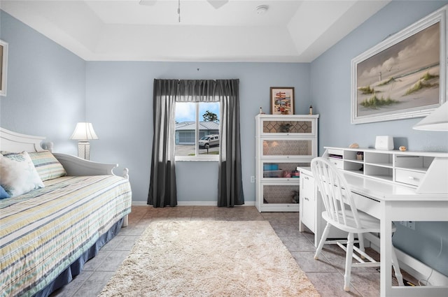 tiled bedroom with a raised ceiling