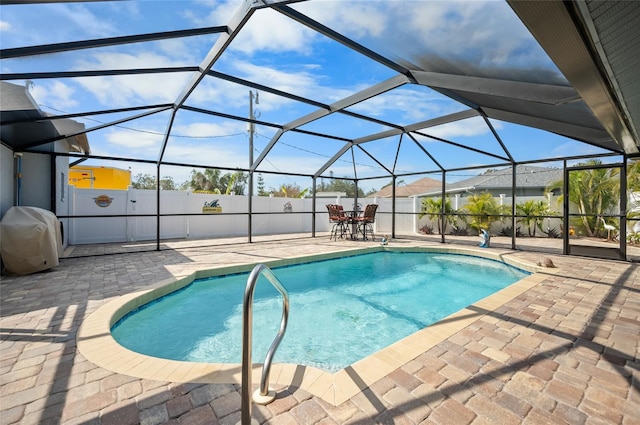 view of swimming pool with a lanai and a patio