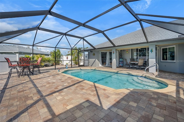 view of swimming pool with a lanai and a patio