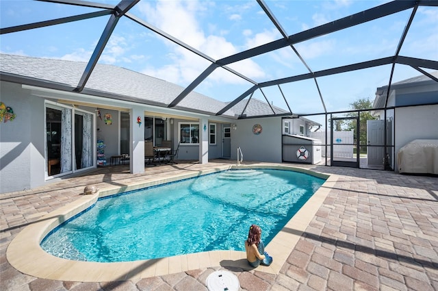 view of swimming pool featuring a lanai and a patio