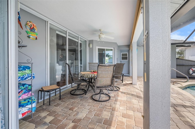 sunroom / solarium featuring ceiling fan