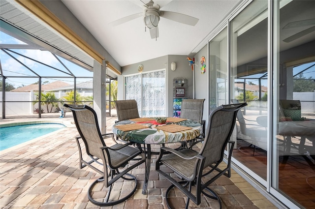 sunroom featuring lofted ceiling and ceiling fan