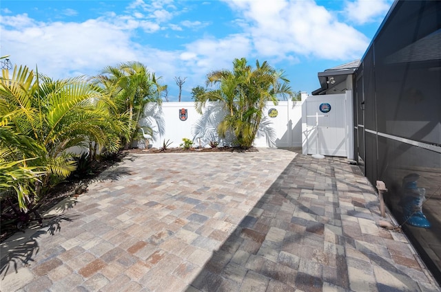 view of patio featuring glass enclosure