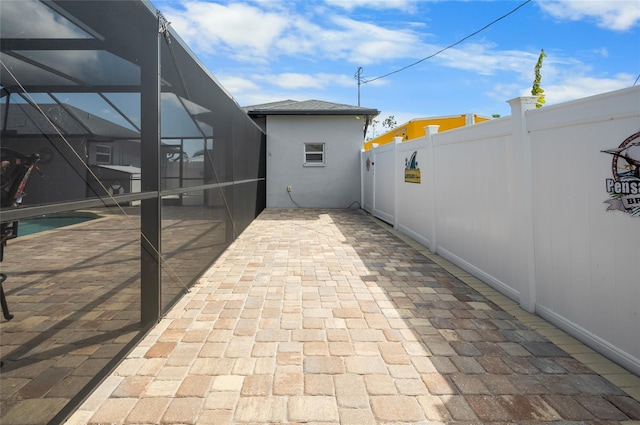 view of patio with glass enclosure