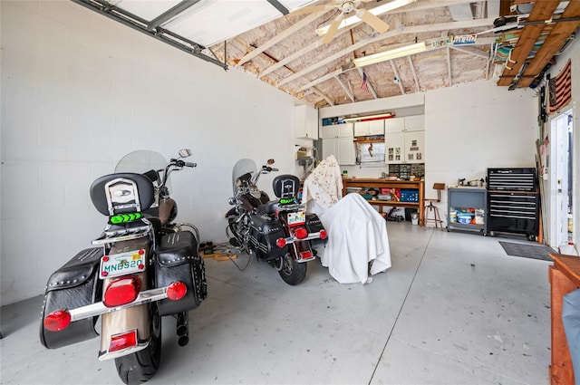 garage with ceiling fan and a workshop area