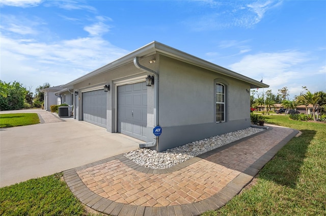 view of side of home featuring a garage and central air condition unit