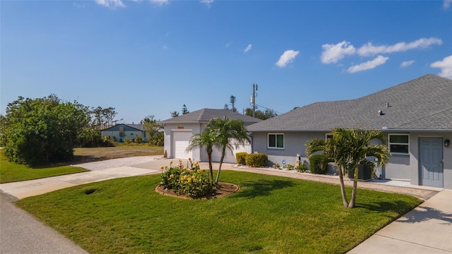 single story home featuring a garage and a front yard