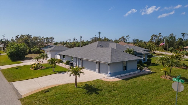 ranch-style home with a garage, a front lawn, and central air condition unit