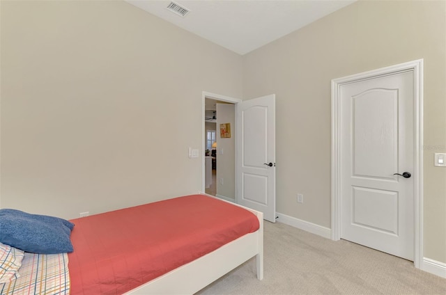 bedroom featuring light colored carpet