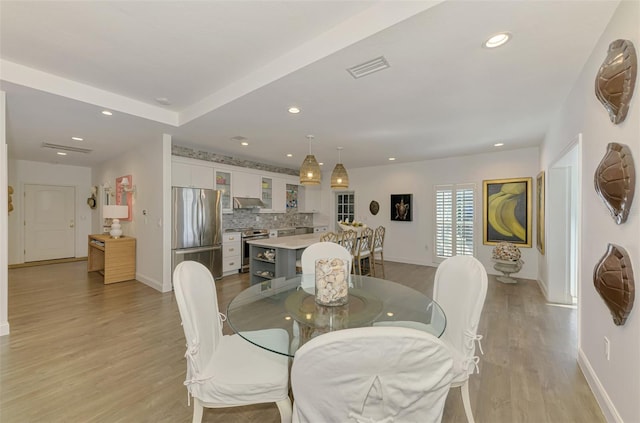 dining space with light wood-type flooring