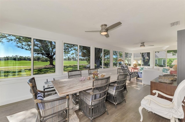 sunroom with ceiling fan and plenty of natural light