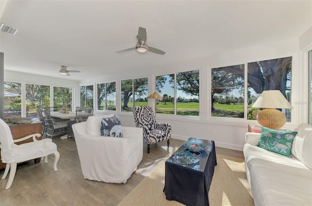 sunroom / solarium featuring ceiling fan