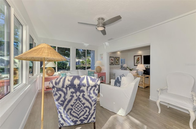 interior space with ceiling fan and light hardwood / wood-style floors