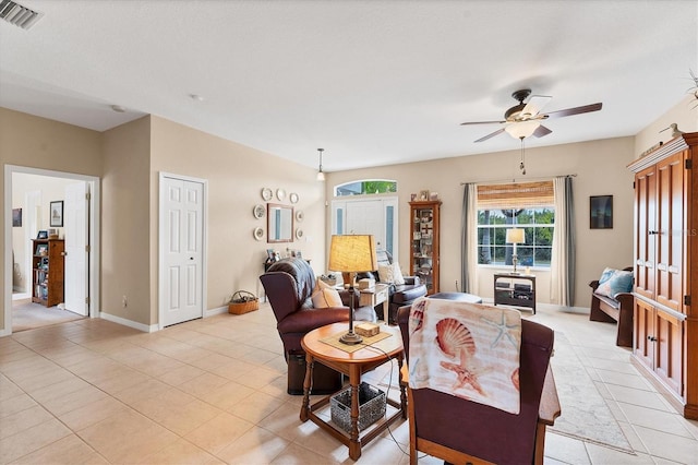 tiled living room with ceiling fan