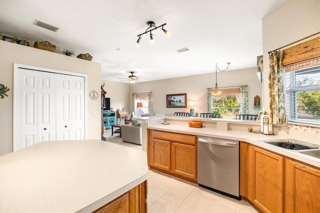 kitchen featuring sink, decorative light fixtures, plenty of natural light, and dishwasher