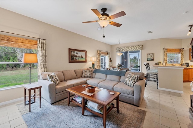 tiled living room with ceiling fan