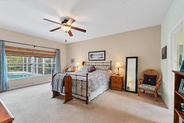 bedroom with ceiling fan and light colored carpet