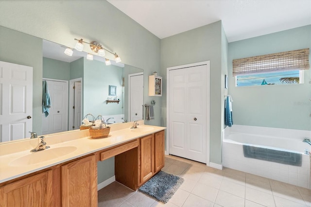 bathroom featuring a relaxing tiled tub, tile patterned floors, and vanity