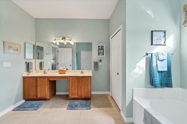 bathroom with vanity, a relaxing tiled tub, and tile patterned floors