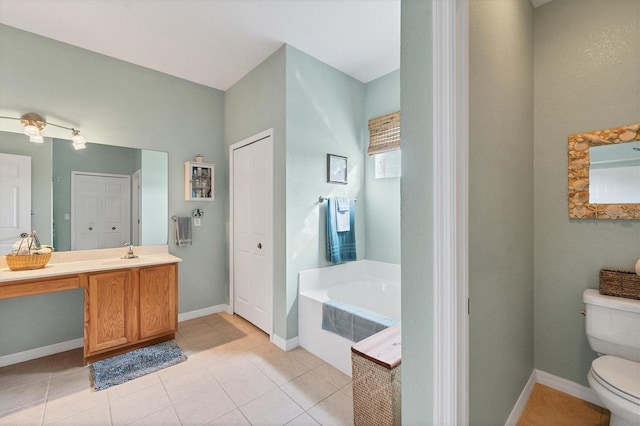 bathroom with vanity, tile patterned floors, a bathing tub, and toilet