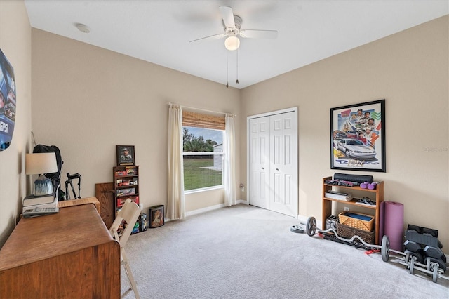 carpeted office space featuring ceiling fan