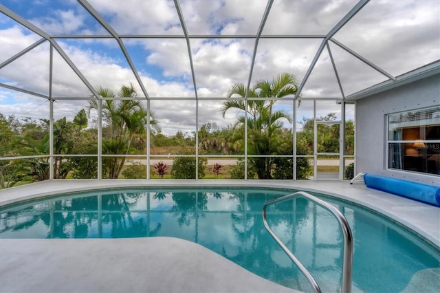 view of swimming pool featuring glass enclosure