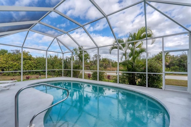 view of swimming pool featuring a lanai and a patio area