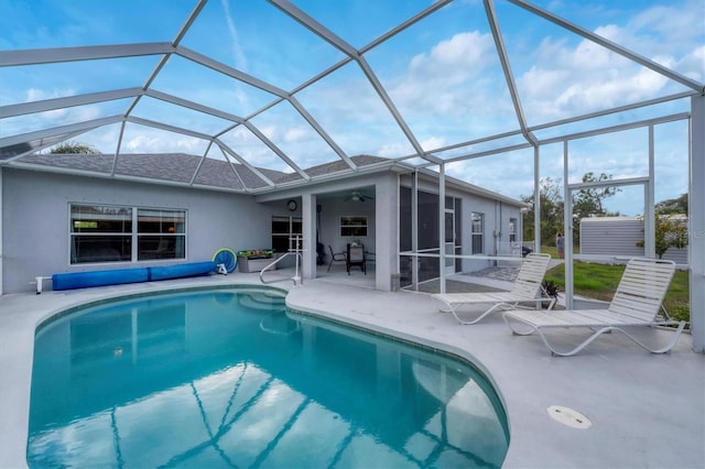 view of pool featuring a patio, ceiling fan, and glass enclosure