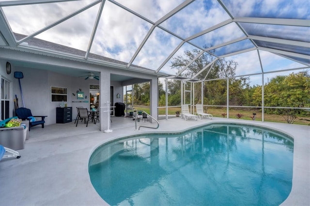 view of pool featuring ceiling fan, a lanai, and a patio