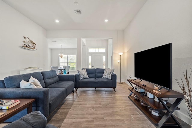 living room featuring hardwood / wood-style floors and a chandelier