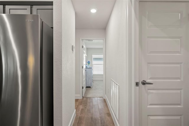 corridor with wood-type flooring