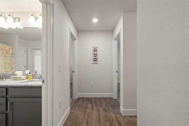 hall with dark hardwood / wood-style floors and sink