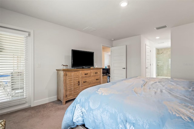 carpeted bedroom featuring connected bathroom