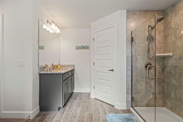 bathroom featuring vanity and a shower with door