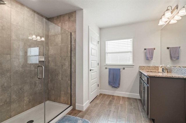 bathroom featuring vanity, hardwood / wood-style floors, and walk in shower