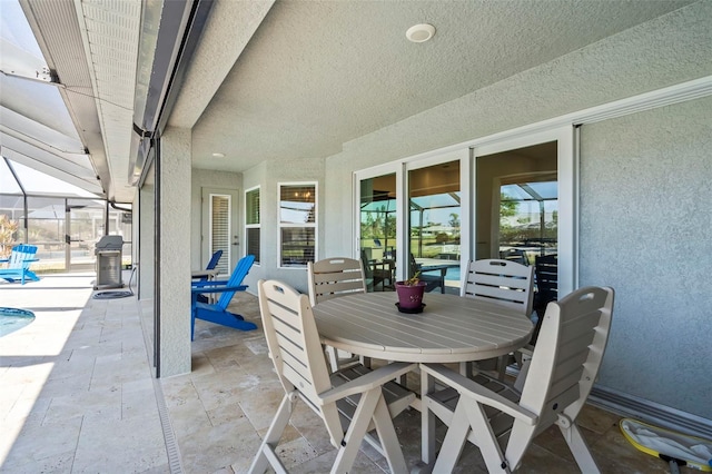 view of patio / terrace featuring glass enclosure