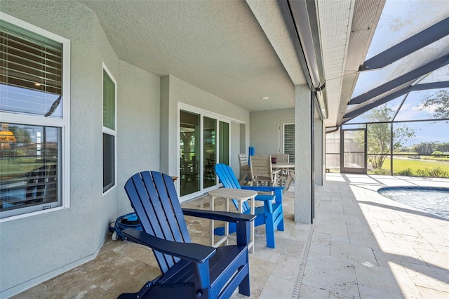 view of patio / terrace featuring a lanai