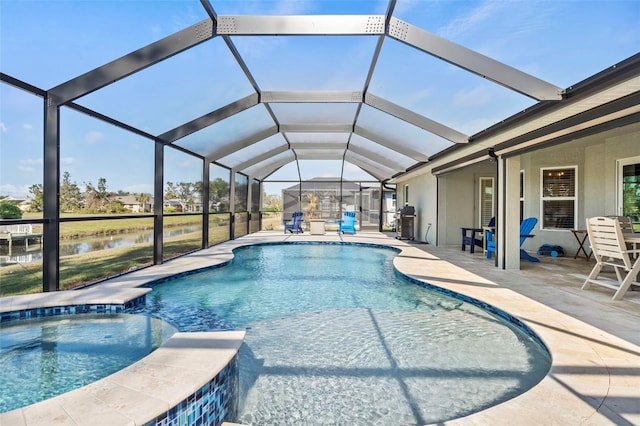 view of swimming pool with a water view, grilling area, a patio, and glass enclosure