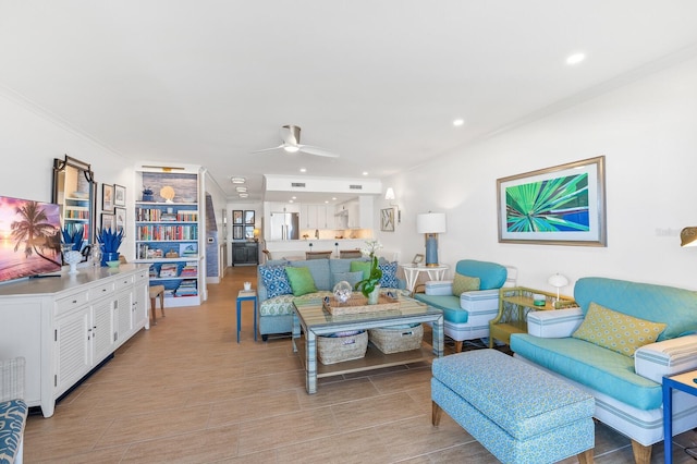 living room with crown molding and ceiling fan