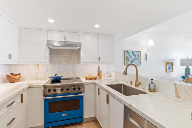 kitchen featuring sink, stainless steel appliances, tasteful backsplash, light stone countertops, and white cabinets