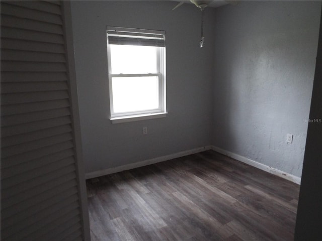 empty room with dark wood-type flooring