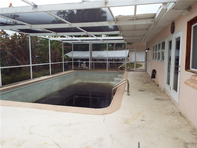 view of pool with a patio and a lanai