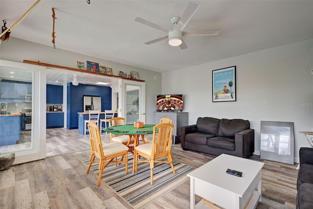 dining area with ceiling fan and light hardwood / wood-style flooring