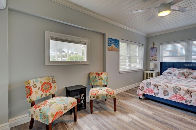 bedroom with multiple windows, crown molding, light hardwood / wood-style floors, and ceiling fan