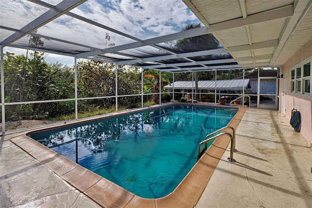 view of swimming pool with a lanai and a patio