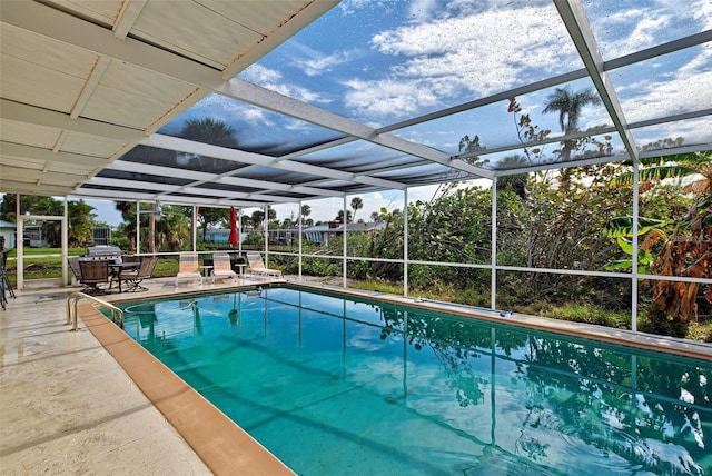 view of pool with a lanai and a patio